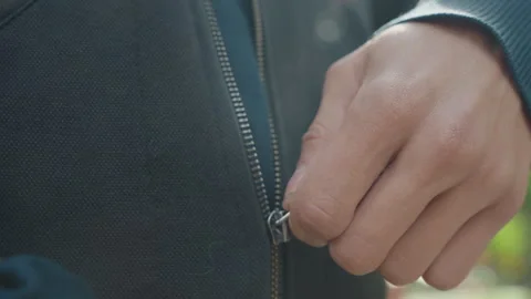 Hands zip jacket, Caucasian man securing jacket zipper during morning routine Stock Footage 329425108