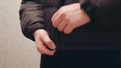 Hands zip jacket. Closeup of clothing details. Focus on jacket zipper and fabric Stock-Footage 337451652