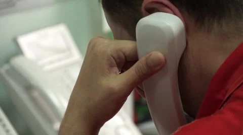 Handset of phone attached to the head Stock Footage 65881672