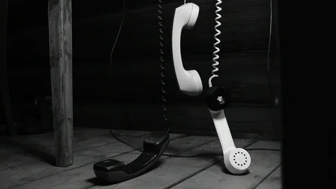 Handsets hanging from the table, black and white Stock Footage 115476489