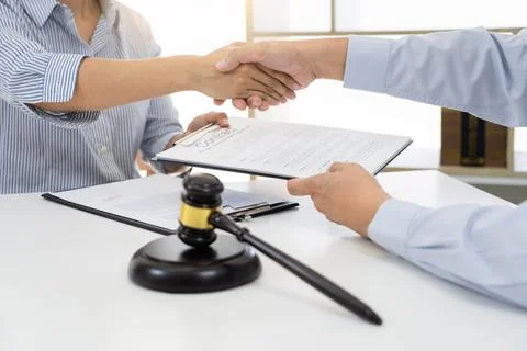 Handshake after cooperation between attorneys lawyer and clients after cons.. Stock Photos
