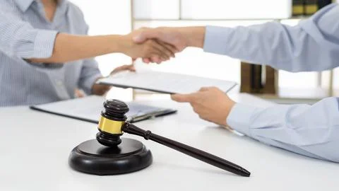 Handshake after cooperation between attorneys lawyer and clients after cons.. Stock Photos