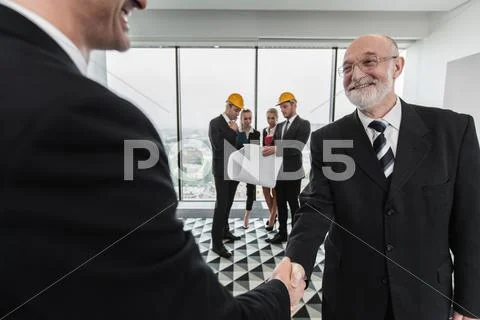 Handshake of architect and investor Stock Photos