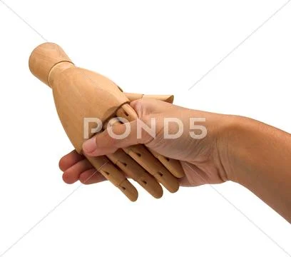 Handshake between a human hand and a wooden hand Stock Photos