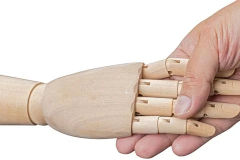 Handshake between human hands and wooden hands is a greeting concept on a w.. Stock Photos