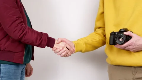 Handshake between photographer and client. Agreement, greeting. Stock Footage 235052271