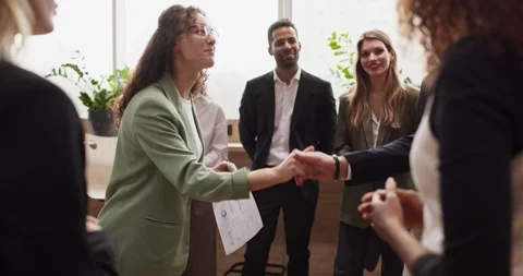 Handshake between professionals at team networking event in modern office Stock Footage 334679103