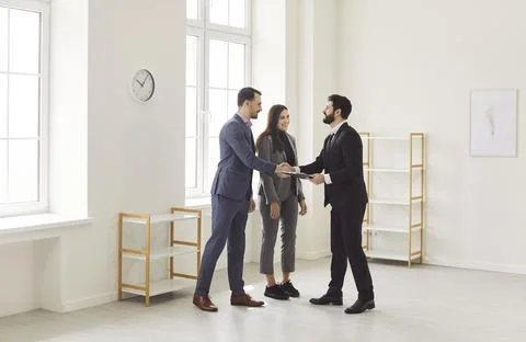 Handshake between realtor and client during property viewing, meeting to sign Stock Photos