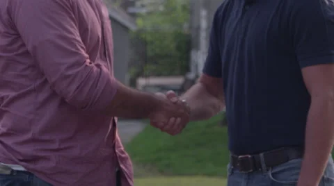 Handshake between two men in the front yard Stock Footage 49872052