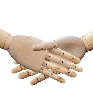 Handshake between two puppet hands made of wood is a concept of hand gestur.. Stock Photos