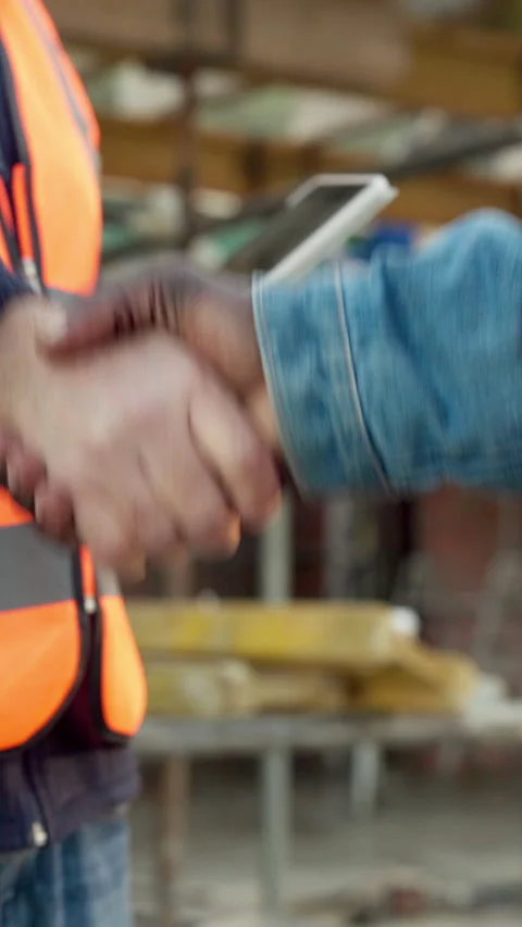 Handshake, construction site and people in team, agreement and tablet with Stock Footage 340892112