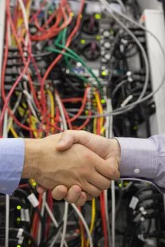 Handshake in front of a data store Stock Photos