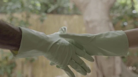 Handshake with gloves - two people shake with latex gloves Stock Footage 126597549
