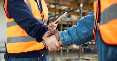 Handshake, men and construction workers on site for agreement on building Stock Photos