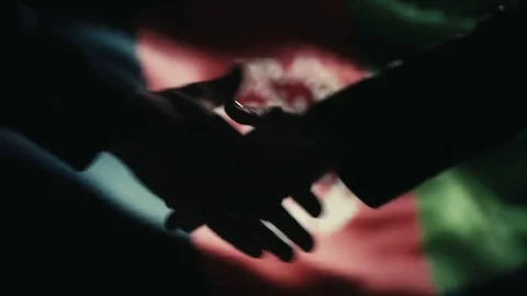 Handshake. Multiple takes. Afganistan flag on LED background. Stock Footage 81016100
