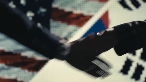 Handshake. Multiple takes. US and Korea flag on LED background. Video stock 85690708