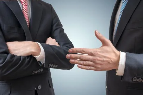 Handshake refuse. Man is refusing shake hand with businessman who is offering Stock Photos
