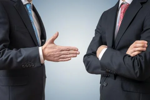 Handshake refuse. Man is refusing shake hand with businessman who is offering Foto stock