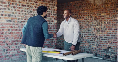 Handshake, team and architect with blueprint for construction, planning or idea Stock Footage 336778348