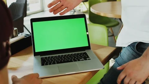 Handshake of two men with background of computer with green screen on the table Stock Footage 112992589