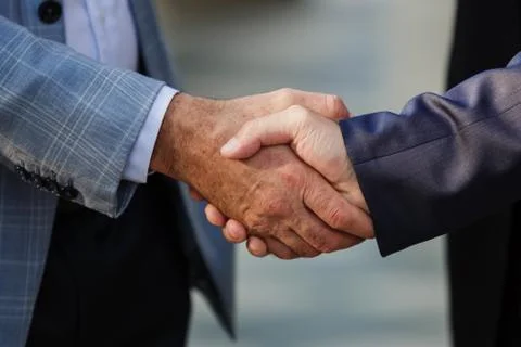 A handshake of two men. Hands close-up. Stock Photos