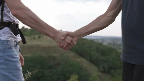 Handshake of two tourists on the top of the mountain Stock Footage 137172001