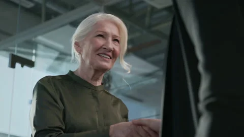 Handshaking of Office Staff Close Up. Elder Cheerful Woman and Matured Businessm Stock Footage 199479233