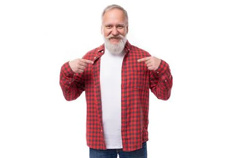 Handsome 60s elderly man with a gray beard points his finger to the side Stock Photos