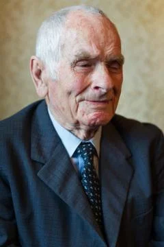 Handsome 80 plus year old senior man posing for a portrait in his house. Stock Photos