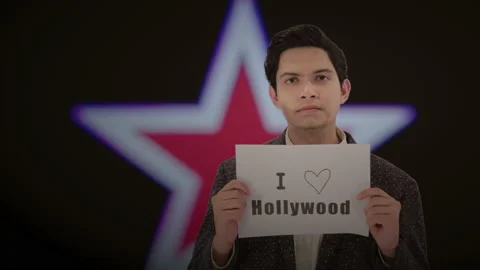 Handsome actor with a glowing star in the background. 4K ProRes Stock Footage 160514849