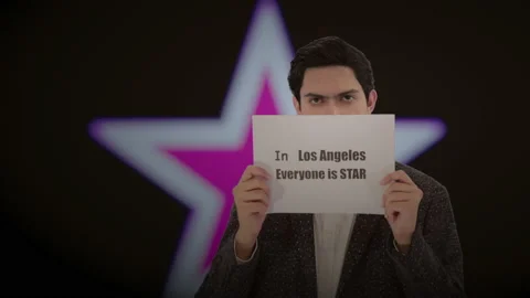 Handsome actor with a glowing star in the background. 4K ProRes Stock Footage 160514896