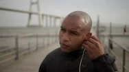 Handsome African America Man Putting Earphones. Stock Footage