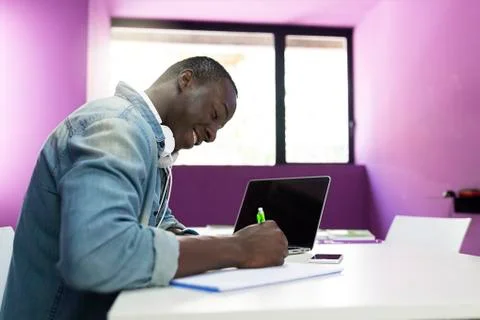 Handsome african man learning at classroom. Stock Photos