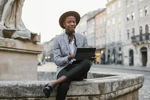 Handsome african man using digital tablet on city street Stock Photos