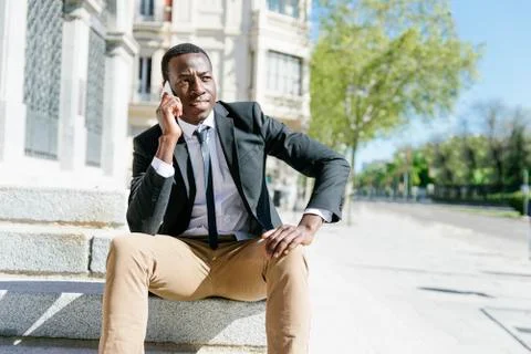 Handsome african man using his mobile. Stock Photos