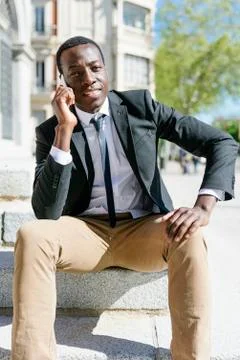 Handsome african man using his mobile. Stock Photos