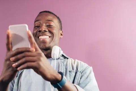 Handsome african man using mobile. Stock Photos