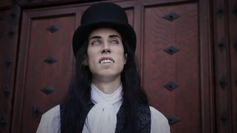 Handsome and mysterious gothic vampire with long black hair walking Stock Footage 284843978