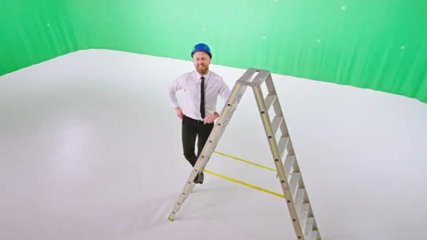 Handsome architect guy with a safety helmets posing in front of the camera while Stock Footage 138889341