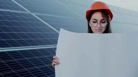 Handsome Architect Woman Examining a Draft Map or Blueprint Project Plan Stock Footage 166473403