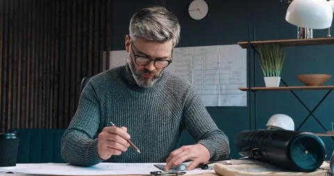 Handsome Architect working at the Office and making Drawings with pencil and Stock Footage 126243104