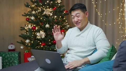 Handsome asian man talking online on video call remotely. Happy New Year Merry  Stock Footage 219912800