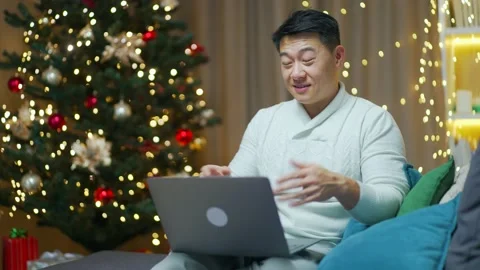 Handsome asian man talking online on video call remotely. Happy New Year Merry  Stock Footage 219913186