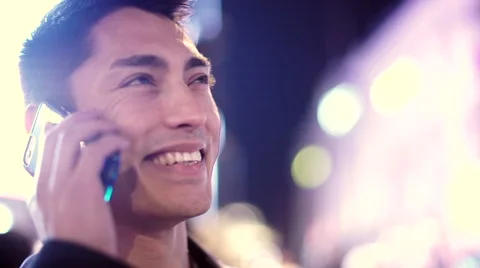 Handsome asian man using his phone in the city at night Video stock 46951982