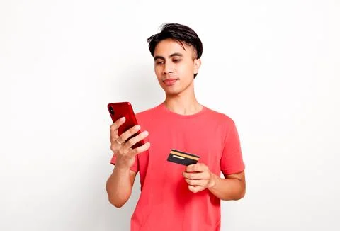 Handsome asian man using smartphone while holding credit card for online sh.. Stock Photos