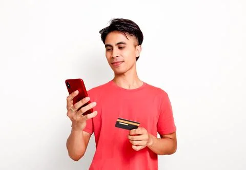 Handsome asian man using smartphone while holding credit card for online sh.. Stock Photos