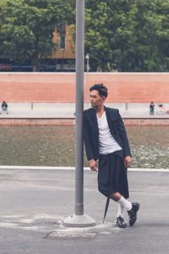 Handsome Asian model posing by an artificial basin Foto stock