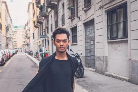 Handsome Asian model posing in the city streets Stock Photos