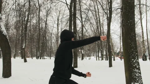 Handsome, athletic guy practising a martial art outdoors Stock Footage 111159275