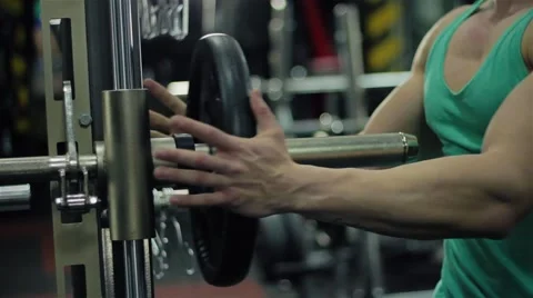Handsome athletic man hangs weight on the press bench to do sport exercize for p Stock Footage 63217747